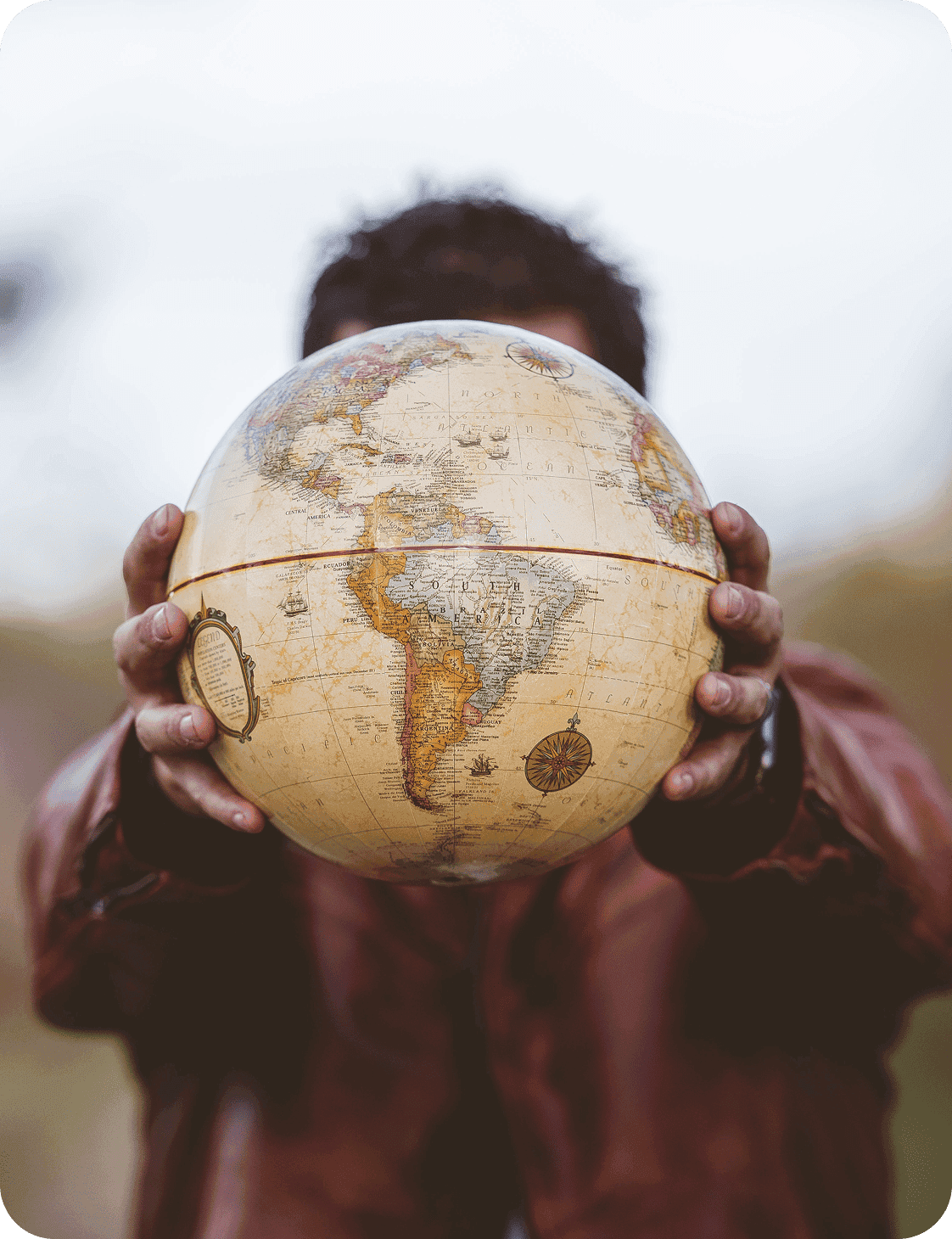 Person holding a globe